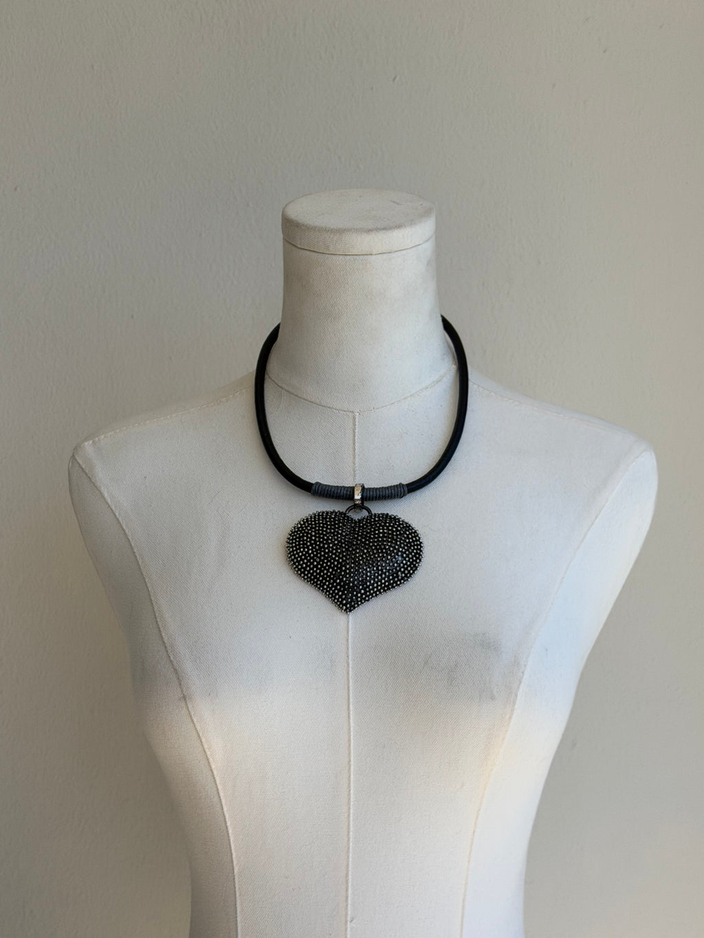 Black beaded heart pendant on sleek collar